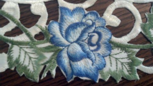 Boutique em doízes gentis com uma rosa azul em tecido de marfim, tamanho 11 polegadas